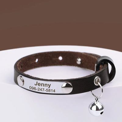 Personalized black leather pet collar with engraved name and phone number, adjustable with silver bell and hardware